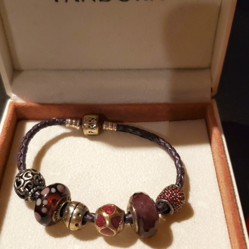 Like brand new pandora Leather nice bracelet 6 charms comes with it.